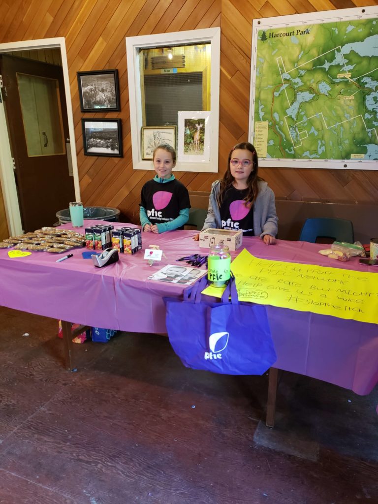 photo of pfic patients at a table selling lemonade.