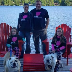 photo of advisory committee leader Lisa Crompton standing with a man, two girls and two bulldogs. 